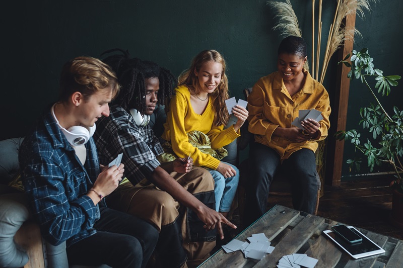 A group of people playing cards